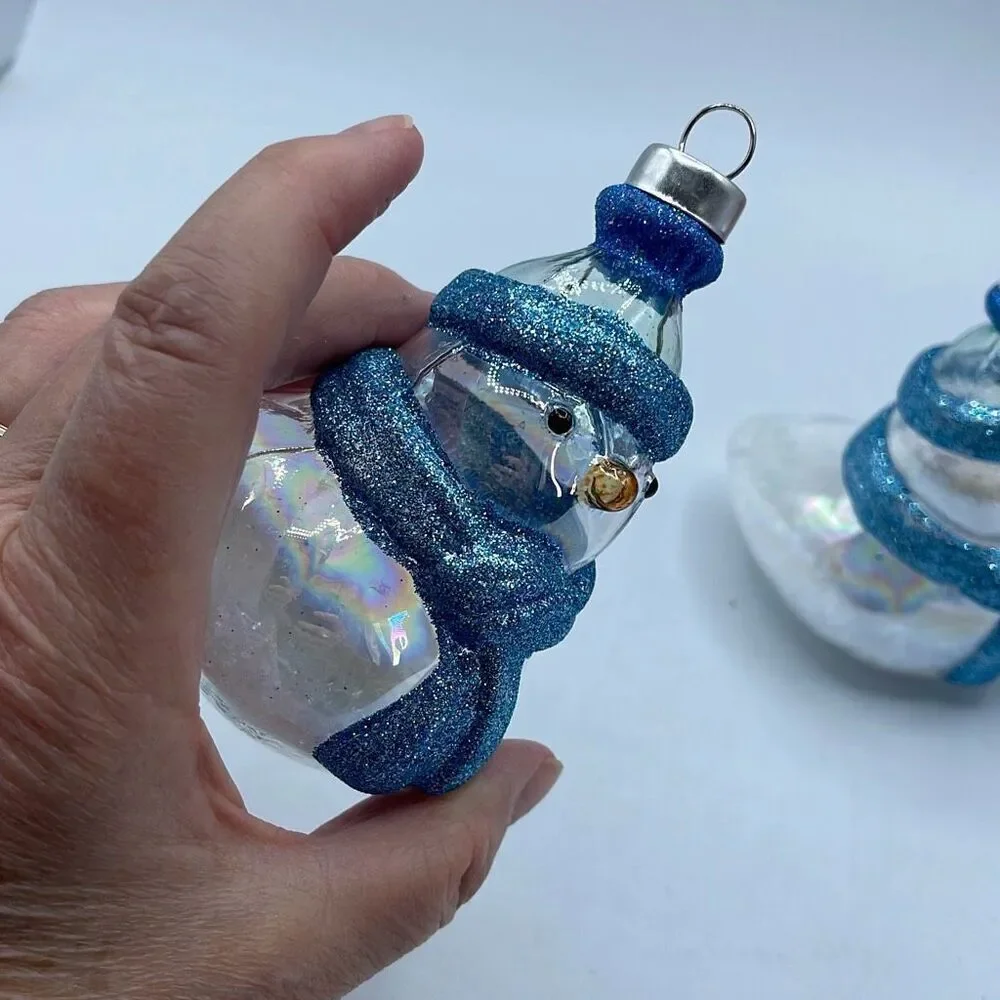 Lot of 2 glass chickadee ornaments with scarves and hats. Faux snow in bottoms.